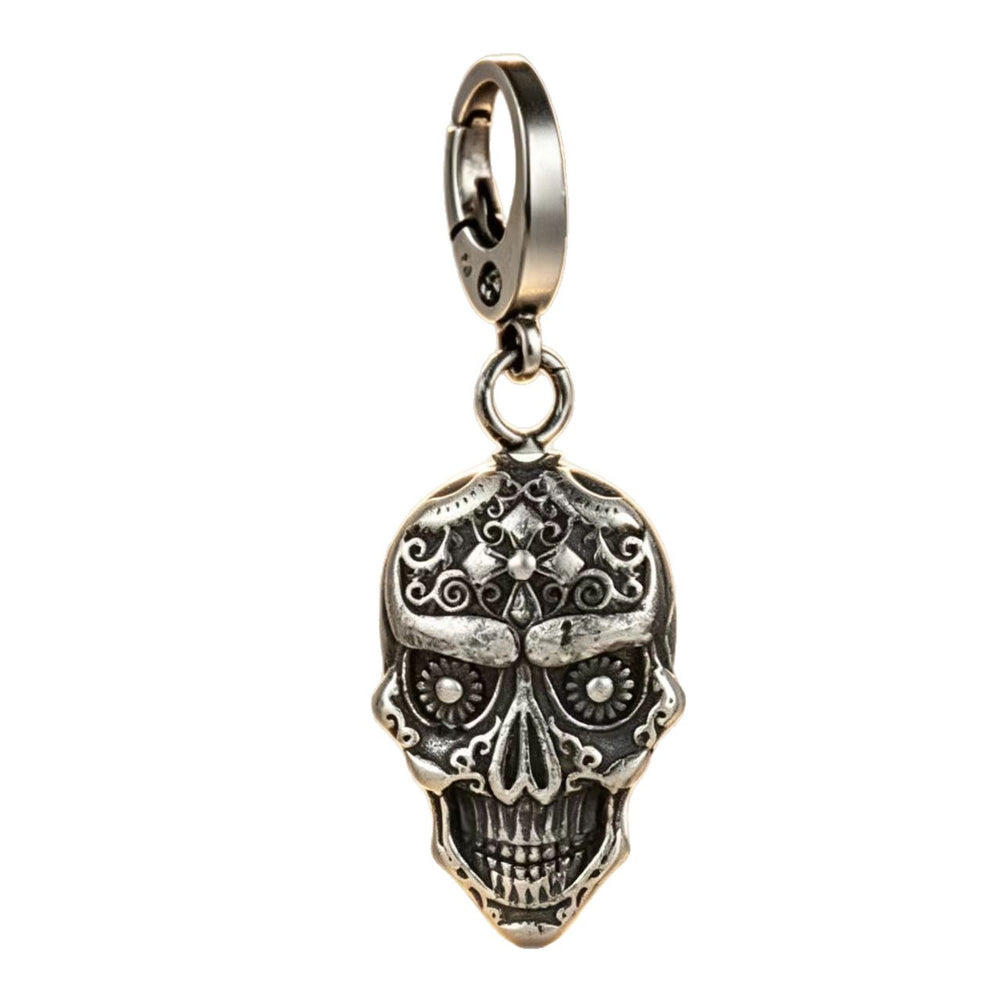 Silver stainless steel skull pendant keychain standing upright on a clean white background showing polished metallic surfaces.