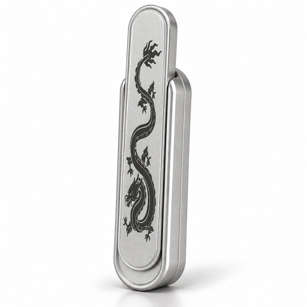 Silver metal magnetic push card fidget with engraved dragon, standing upright on white