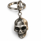 Vintage silver skull pendant keychain with split ring and swivel clasp on white.