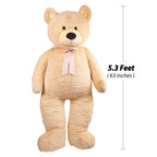 Large beige teddy bear with a measurement label indicating its height.