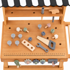 Elevated tabletop view showing the workbench wooden tools, ruler and threaded hardware.