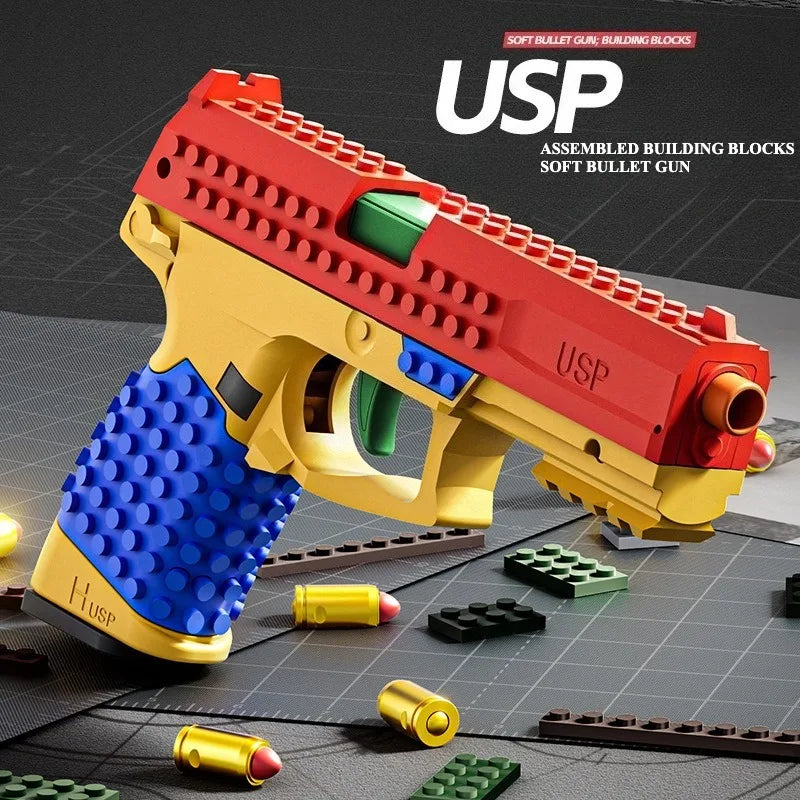 Toy gun made of interlocking building blocks with 'USP' branding on a dark surface.