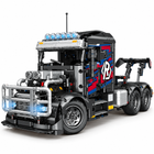 Close-up of the semi-tractor's silver engine, front grille, bull bar, lights and cab details