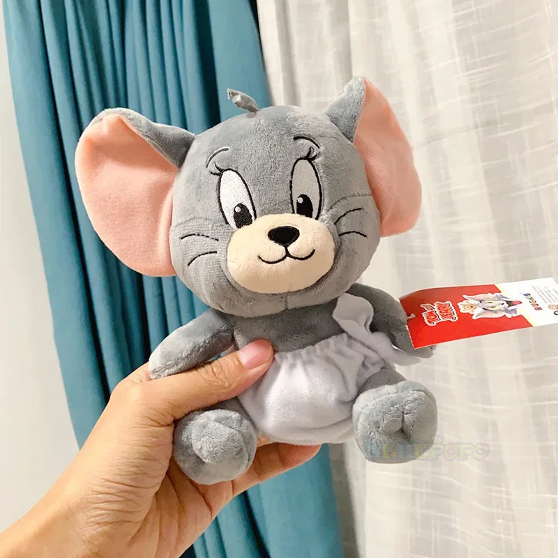 Plush toy resembling a cartoon character held by a hand with a light background