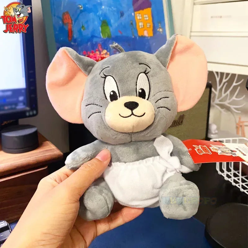 Plush toy resembling a cartoon character held by a hand in an indoor setting.