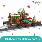 Toy train set with a station and festive decorations on a white background, featuring the brand 'Toylivia Toys'.