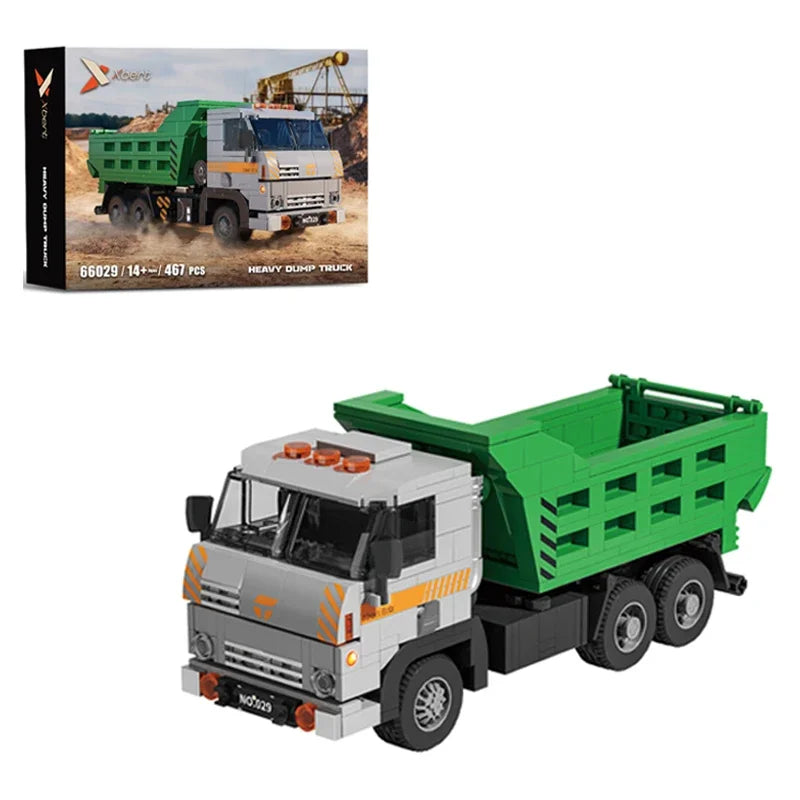 Toy dump truck with green bed and gray body, displayed with packaging in the background.
