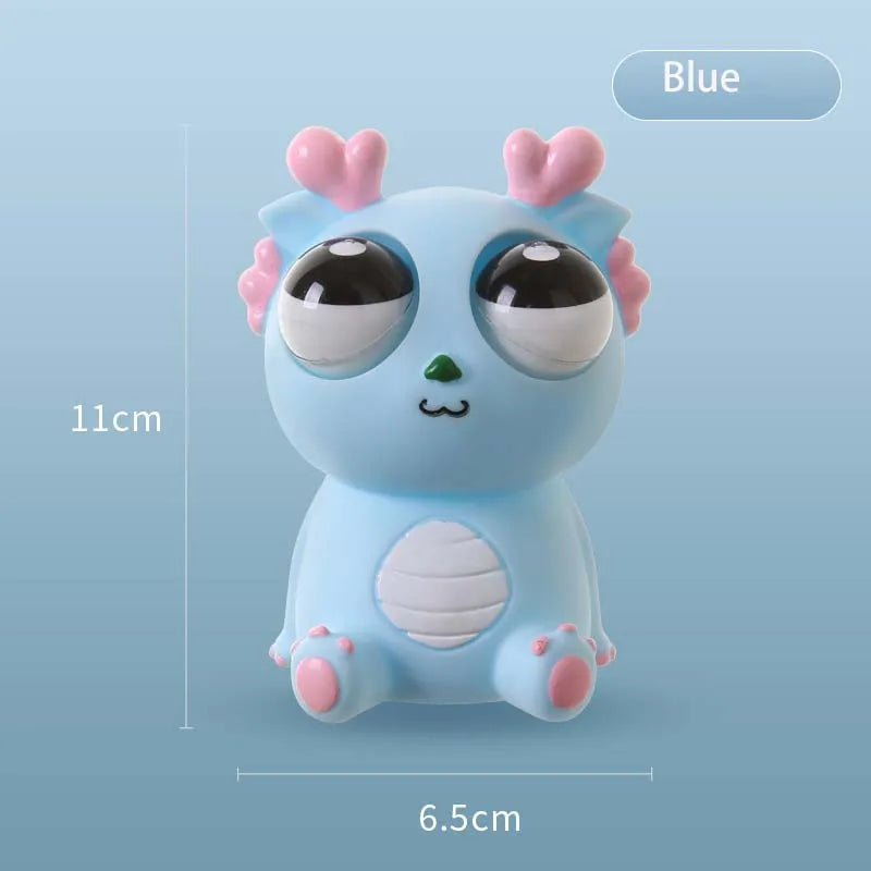 Blue pop-out eyes dragon squeeze fidget toy with size measurements, approximately 11 cm tall and 6.5 cm wide
