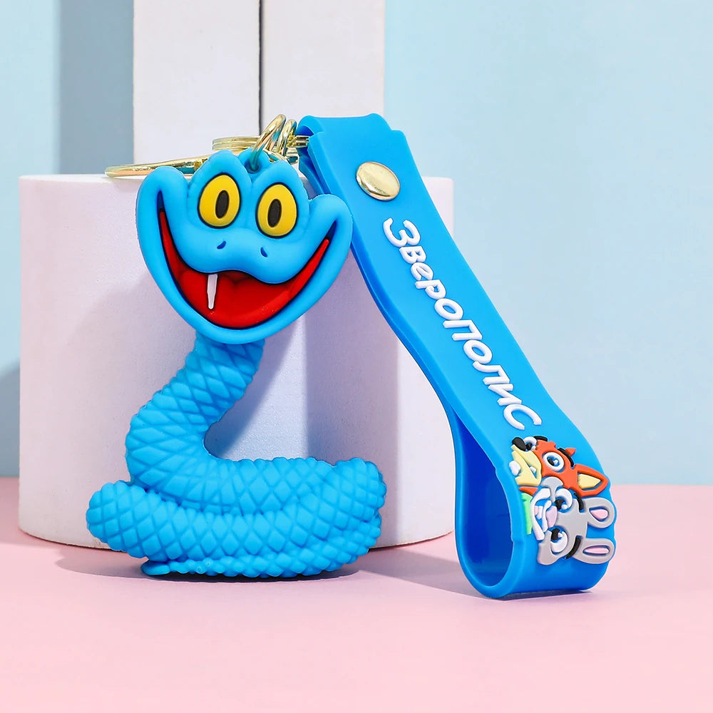 Single blue cartoon snake keychain with textured body and smiling face, silicone keychain on pastel background
