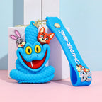 Blue cartoon snake keychain with silicone strap, smiling snake figure displayed on pastel background