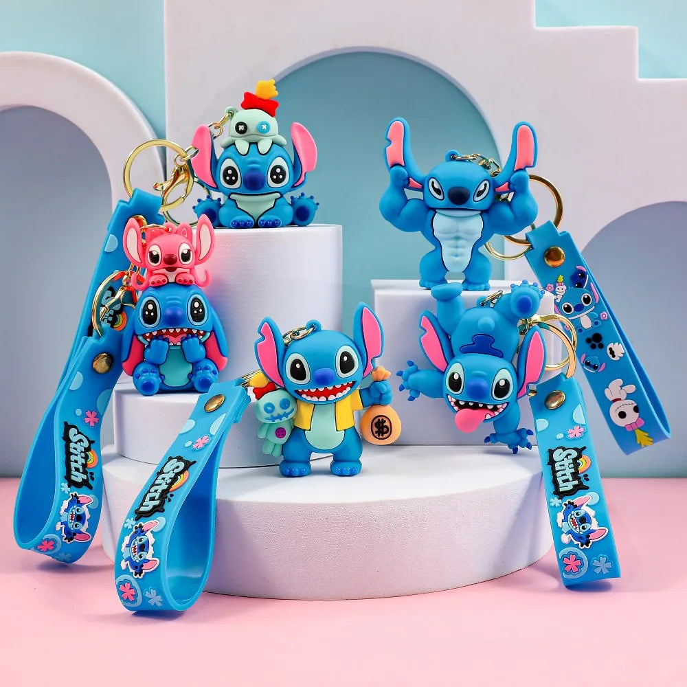 Christmas Stitch PVC keychain collection with multiple blue cartoon designs displayed on a pastel platform Main image