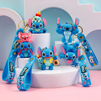 Christmas Stitch PVC keychain collection with multiple blue cartoon designs displayed on a pastel platform
