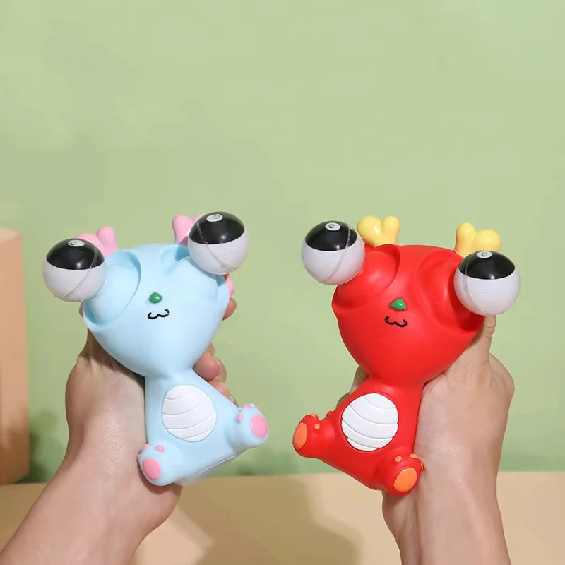 Pop-out eyes dragon squeeze fidget toys being squeezed by hands in blue and red colors