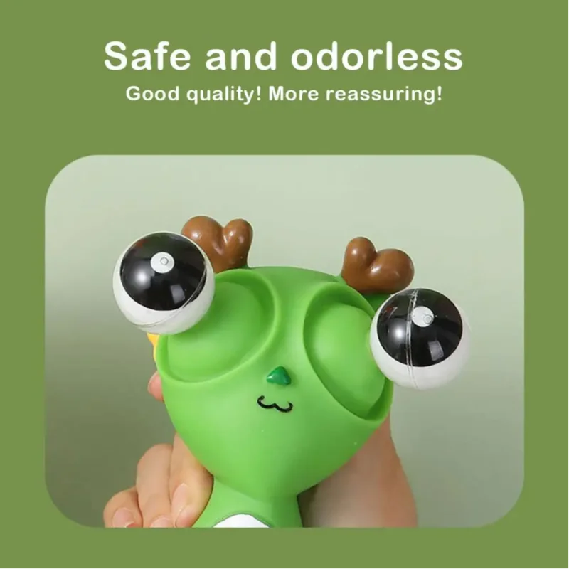 Green pop-out eyes dragon squeeze fidget toy being squeezed by hand, showing safe and odorless material