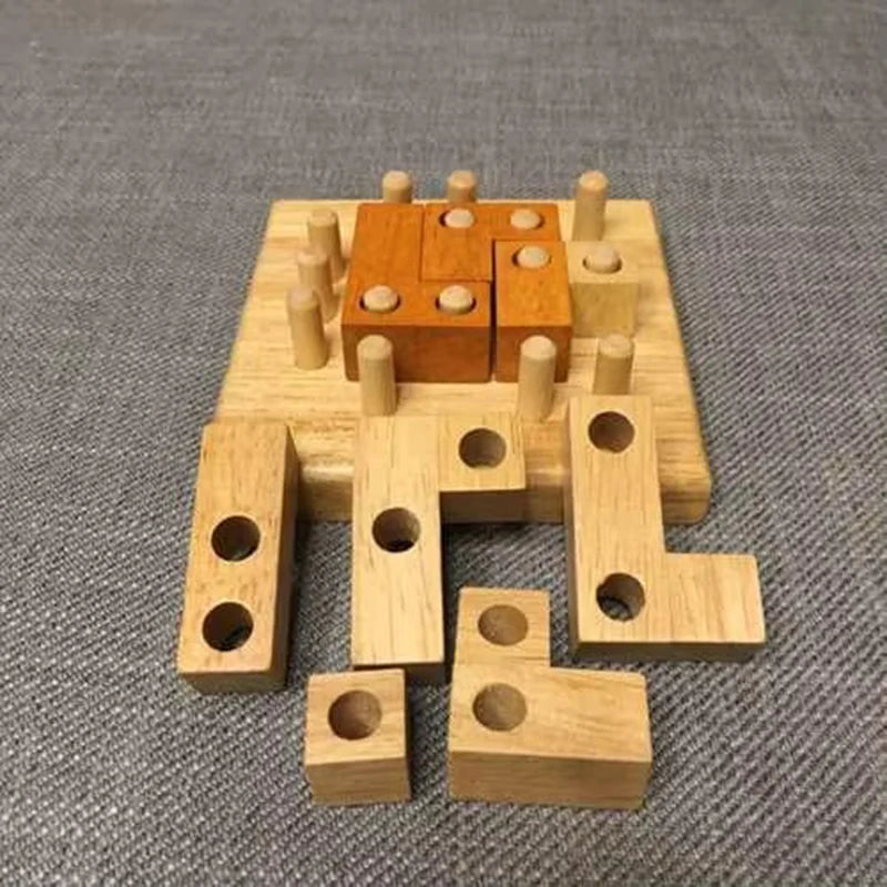 Partially assembled geometric wooden brain teaser puzzle showing block placement on peg board