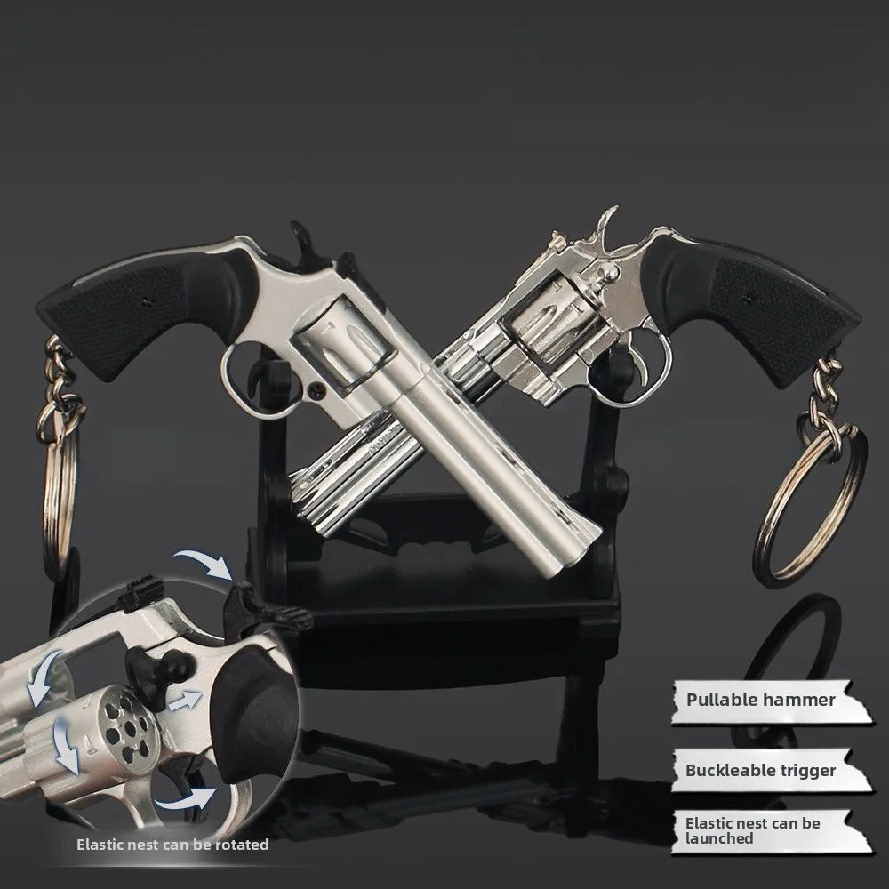 Silver alloy revolver keychain model on stand with rotating cylinder and pullable hammer