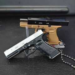Mini scale pistol model keychains displayed on a dark surface, decorative collectible models