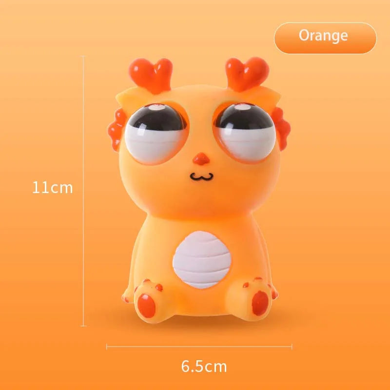 Orange pop-out eyes dragon squeeze fidget toy with size measurements shown on orange background