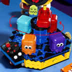 Close-up of Pac-Man building block base showing rotating ghost figures and joystick detail – Toylvia collectible set