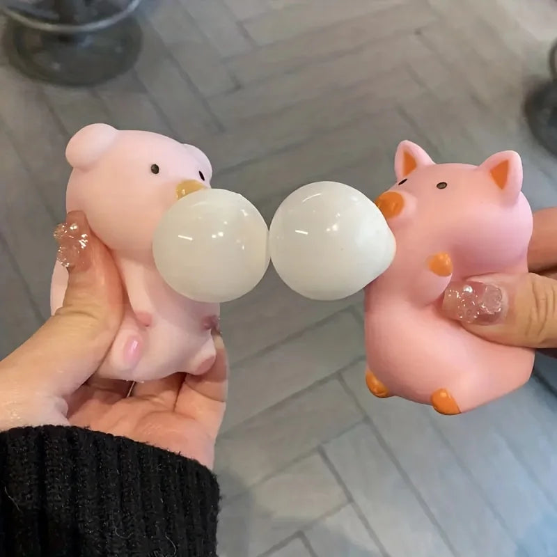 Cute pink pig squishy fidget toys being squeezed to blow bubbles, stress relief sensory toy for kids and adults by Toylvia™
