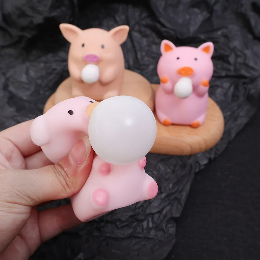 Pink pig bubble squishy toy blowing bubble with other pig fidget toys displayed behind, soft sensory stress relief toy