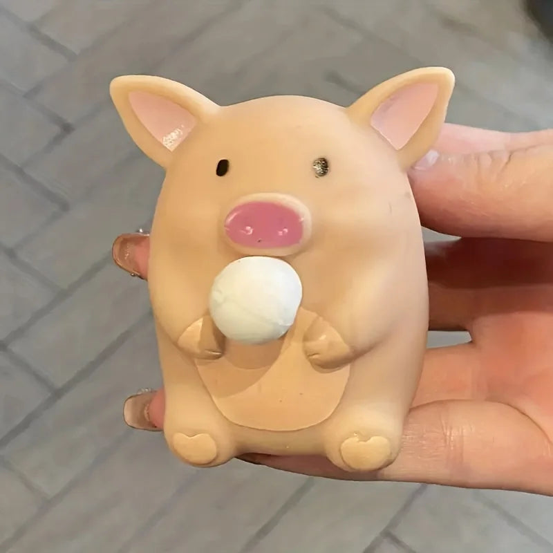 Beige pig squishy fidget toy with white bubble held in hand for stress relief