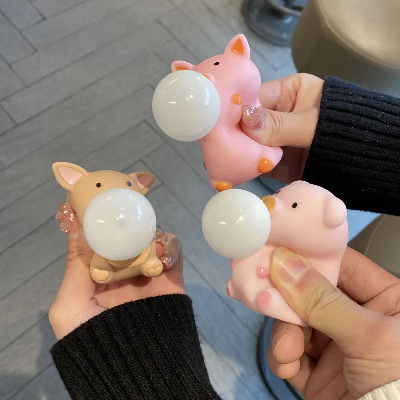 Three pig squishy bubble fidget toys squeezed by hands showing stress relief action