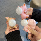 Three pig squishy bubble fidget toys squeezed by hands showing stress relief action