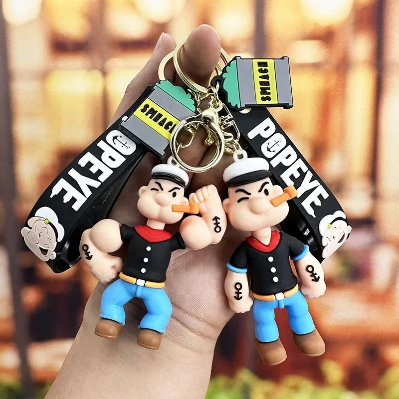 Toylvia Popeye Kawaii Keychain with cartoon PVC figure and printed strap held in hand.