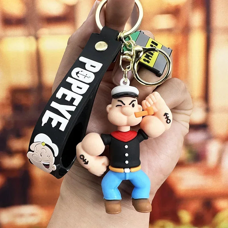 Toylvia Popeye Kawaii Keychain displayed in hand showing PVC cartoon figure flexing pose.