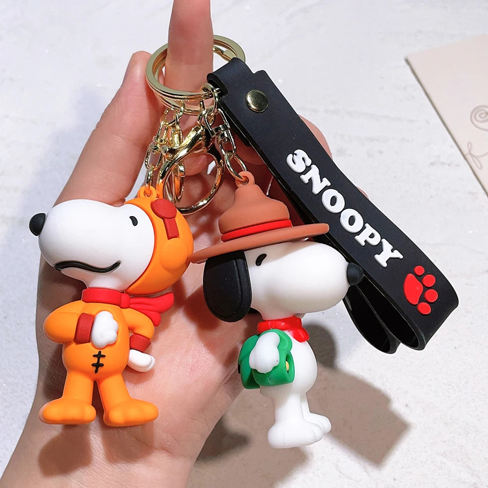Snoopy silicone keychain set with orange suit and hat style held in hand