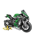 technical motorcycle building blocks model in green and black displayed on stand against white background