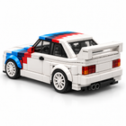 Clean white studio rear three-quarter view of the Velocity Edge white, red and blue sports car building-block model.