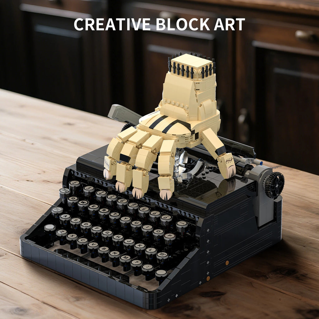 Wednesday Typewriter building blocks set displayed as creative block art with robotic hand on a wooden desk
