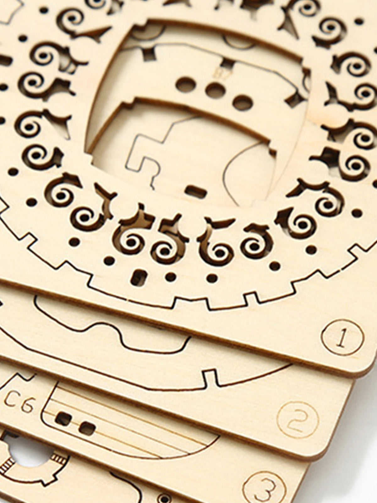 Laser-cut wooden puzzle pieces used to assemble the steampunk airship model