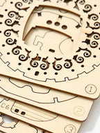 Laser-cut wooden puzzle pieces used to assemble the steampunk airship model