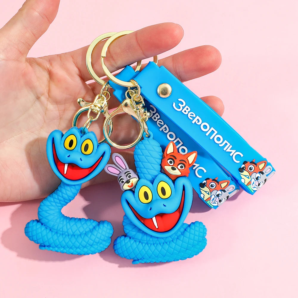 Zootopia 2 Gary blue snake PVC keychain with strap, held in hand on pink background
